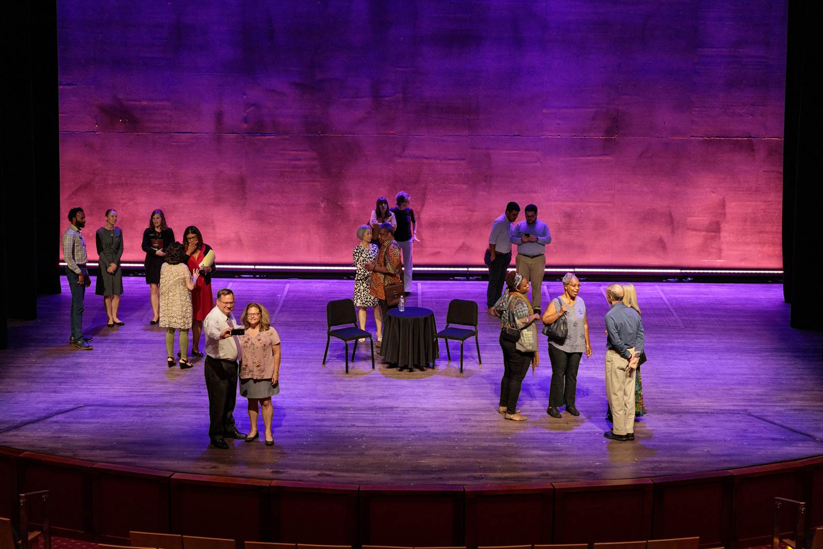Kennedy Center Members standing on stage during a reception.